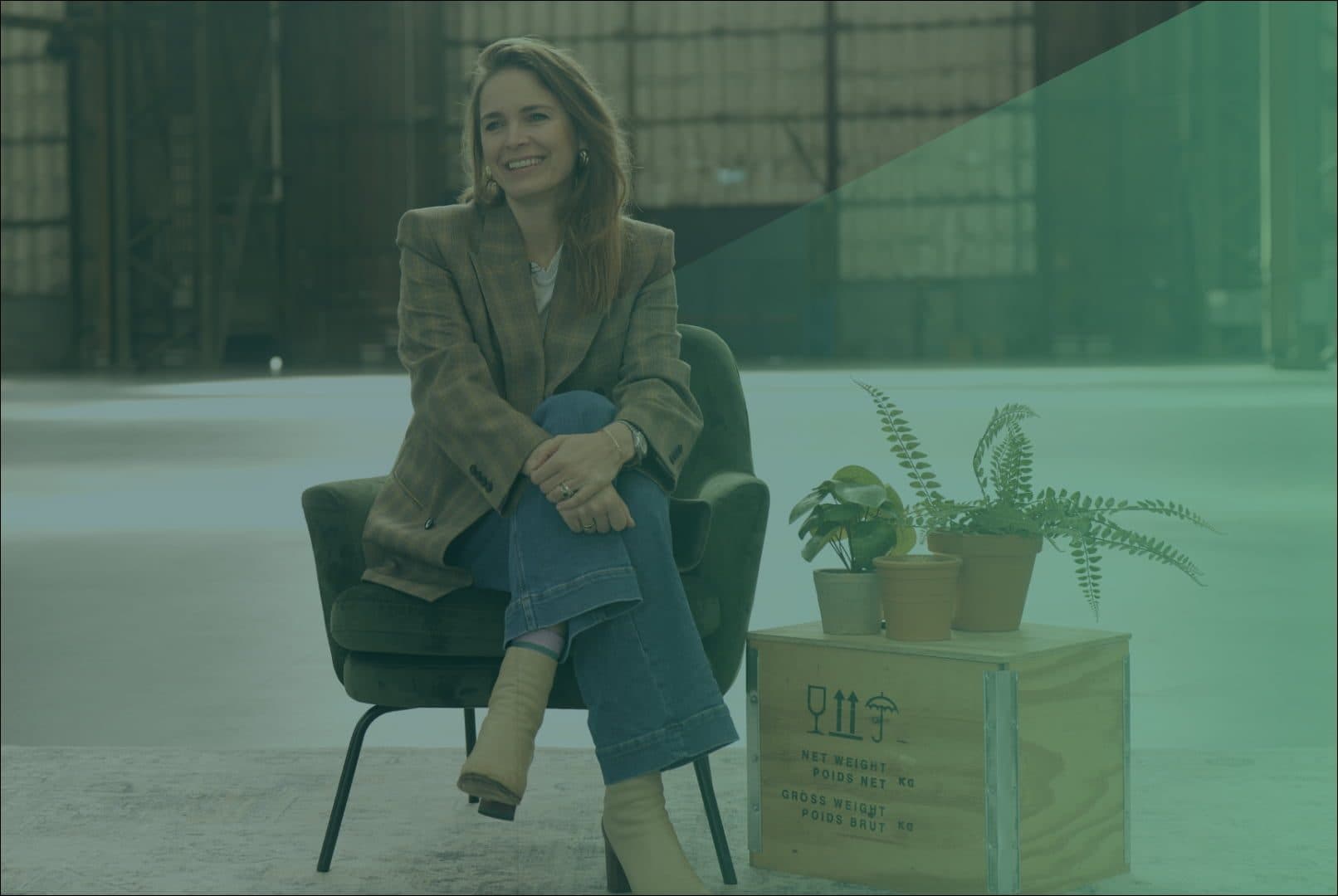 Hanna Verboom glimlachend zittend op een stoel kijkend naar de zijkant met groene gloed over zich
