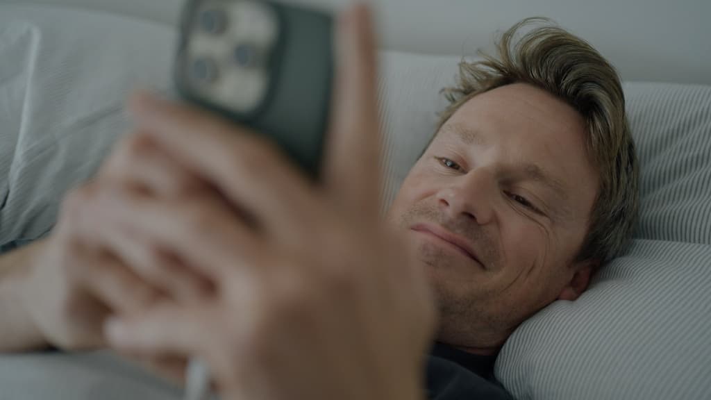 Sander Schimmelpenninck kijkt liggend naar telefoon