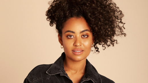 Ciana Mayam voor beige muur en krullen