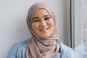 Houda Loukili lachend met bij het raam