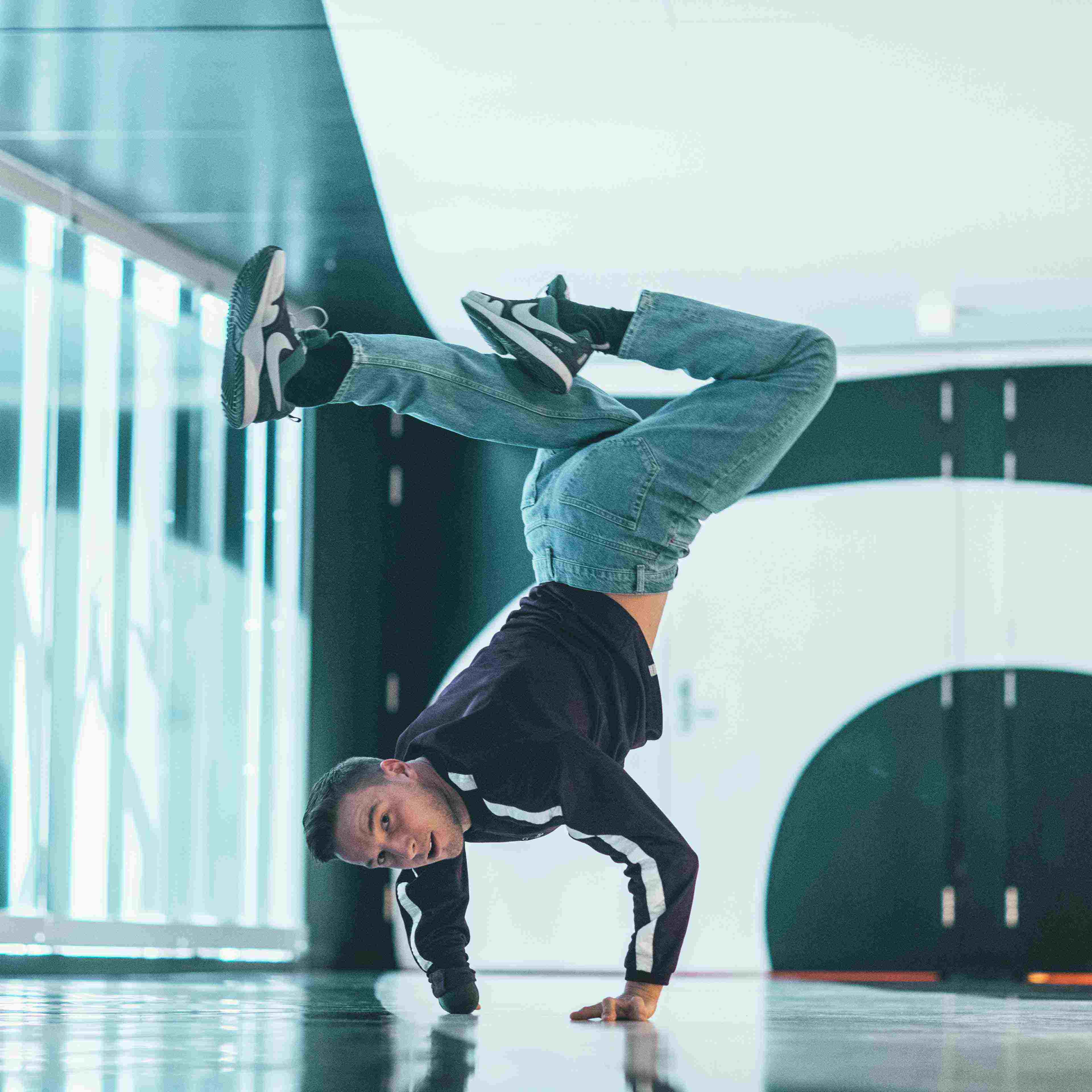 Redouan Ait Chitt poseert in handstand in gebouw