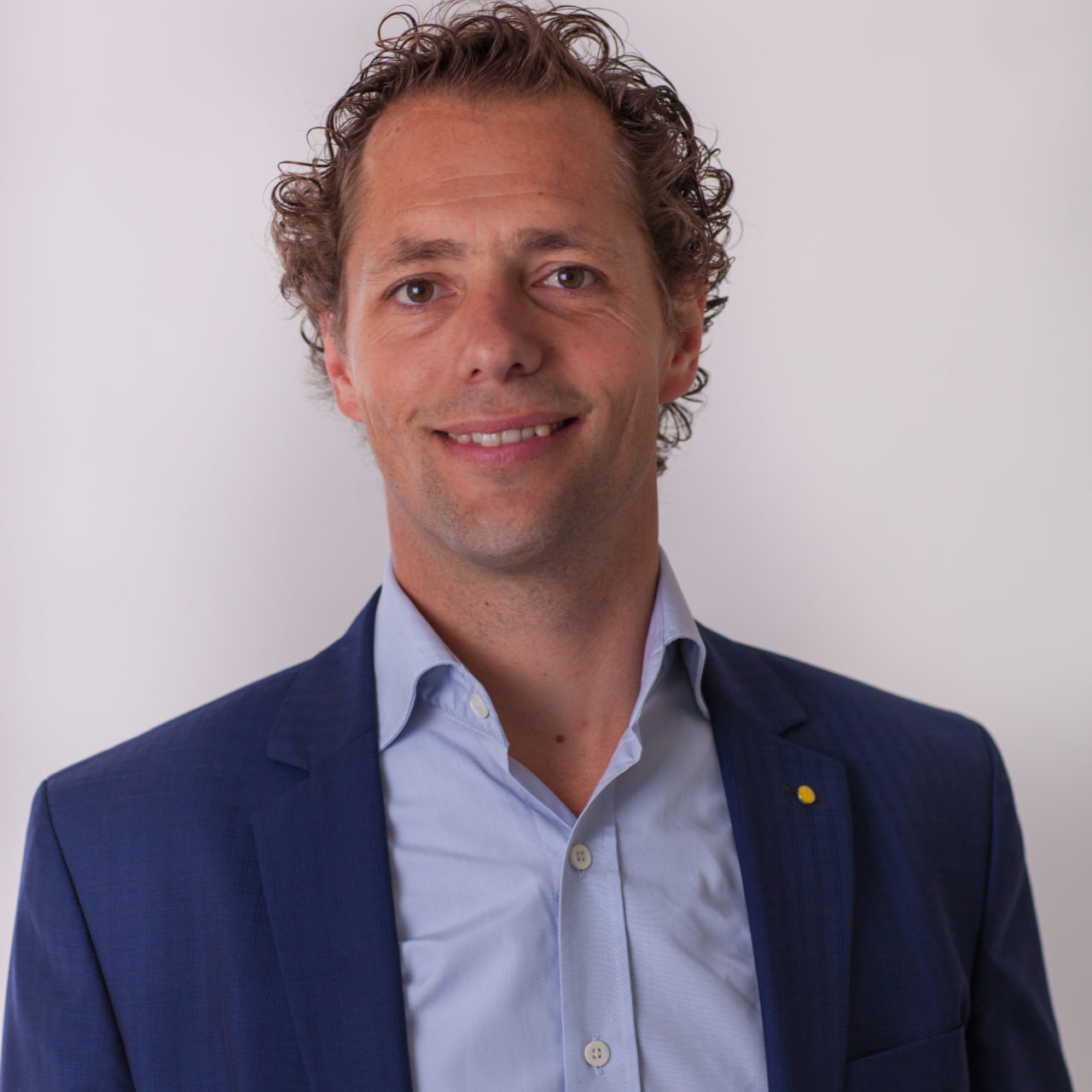 Joost van der Weijden lachend met grijze achtergrond